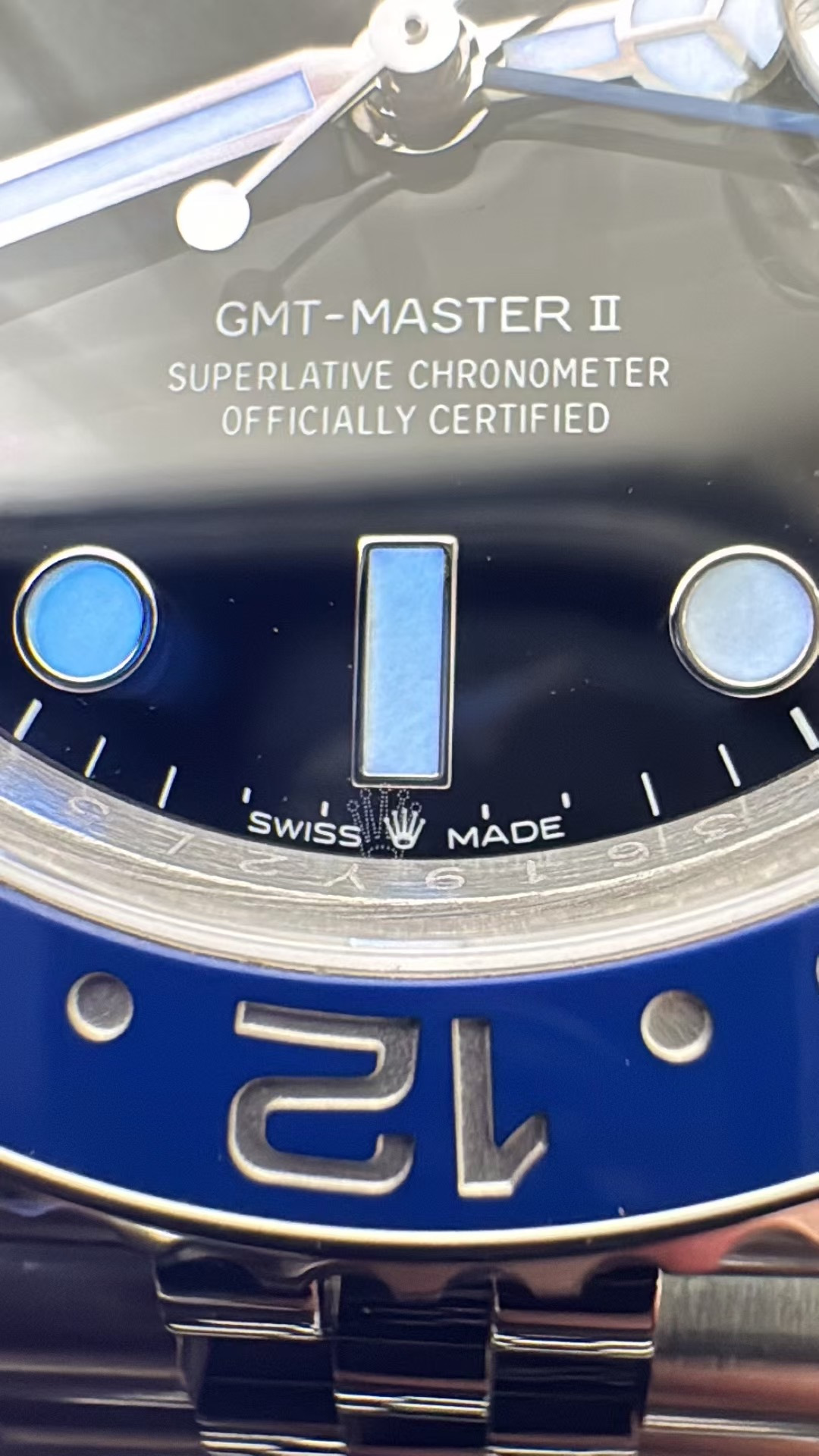 Macro close-up of the VSF GMT-Master II 6 o'clock text, printed coronet, and inner bezel engravings