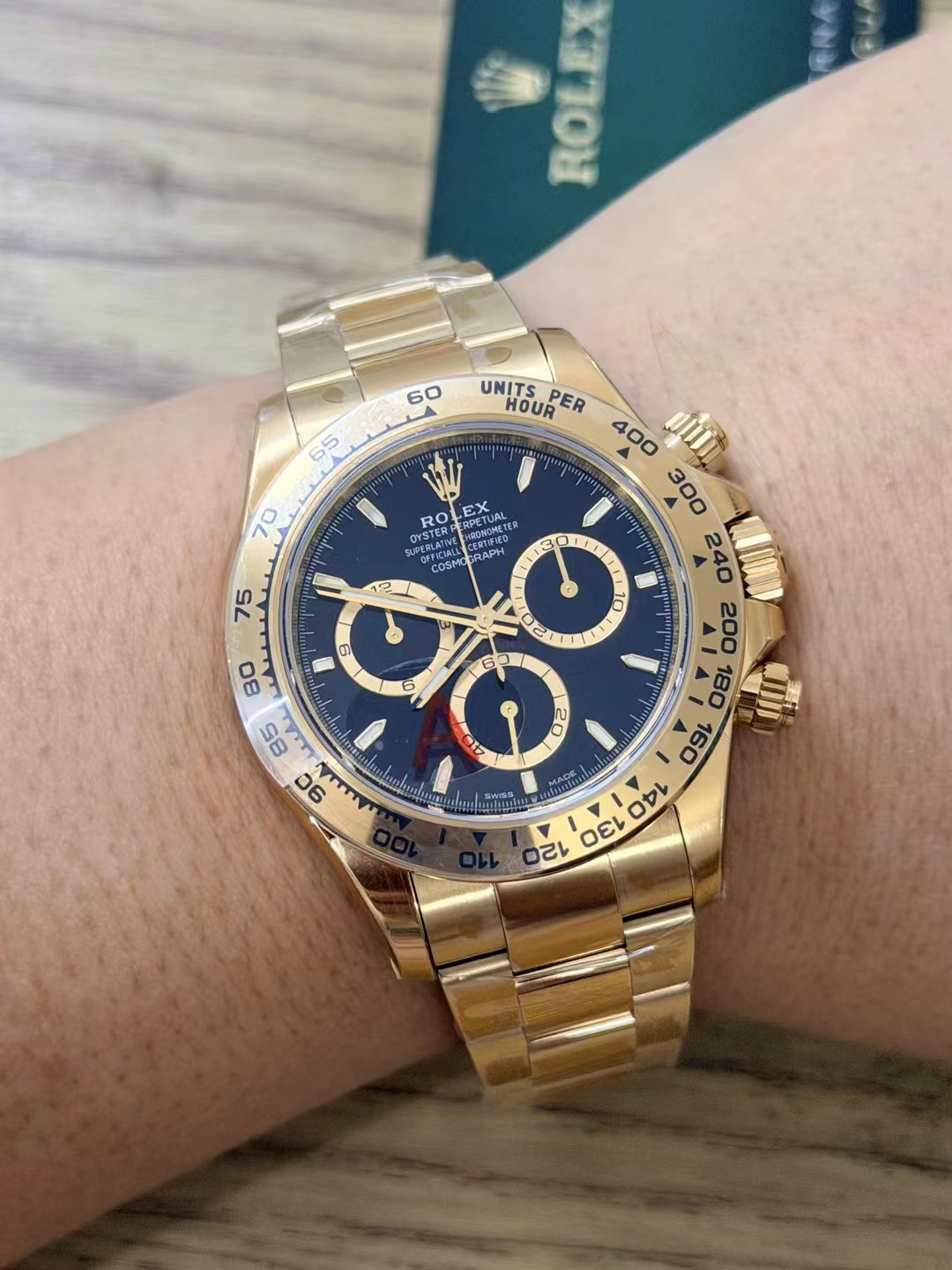 Front wrist shot of the full Yellow Gold VS Factory Daytona 126508 with black dial