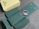 Rolex premium green watch case holding a watch